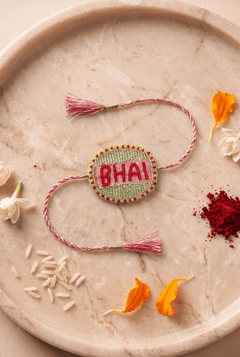 Beautifull handcrafted Green and Silver Embroidered Rakhi with Pink Braded Thread Tassels - Western Era Rakhi for women