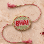 Beautifull handcrafted Green and Silver Embroidered Rakhi with Pink Braded Thread Tassels - Western Era Rakhi for women