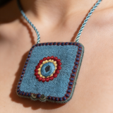 Necklace Featuring A Textured Turquoise Pendant Detailed With Vibrant Thread Embroidery