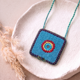 Necklace Featuring A Textured Turquoise Pendant Detailed With Vibrant Thread Embroidery