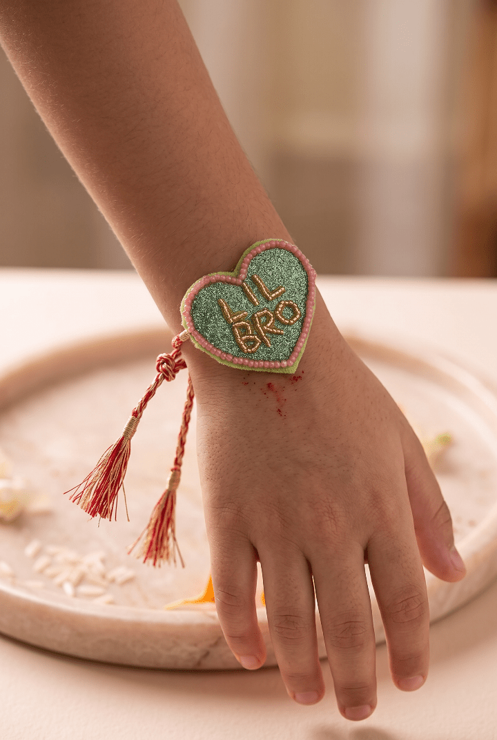 Olive Green Heart Shape Rakhi with Pink Bead Work - Western Era Rakhi for women