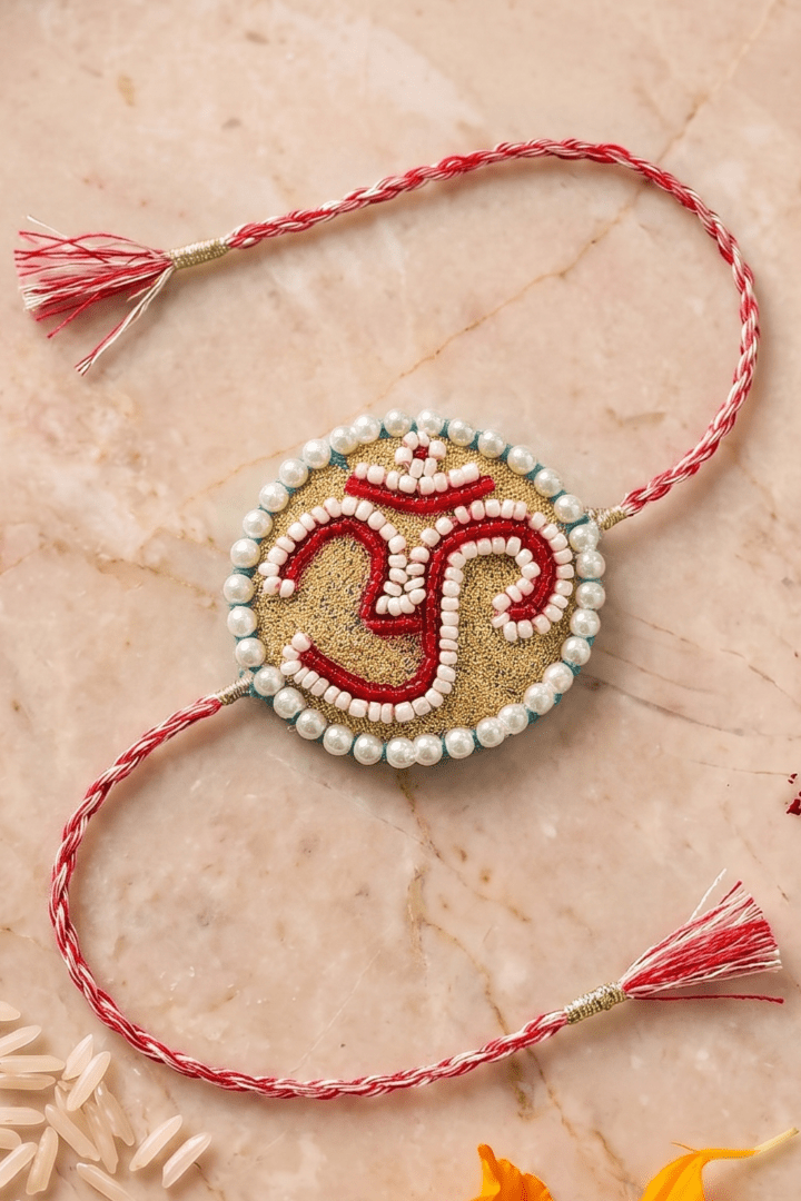 Om Motif Embellished with Red, White, and Golden Beadwork Rakhi - Western Era Rakhi for women