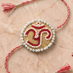 Om Motif Embellished with Red, White, and Golden Beadwork Rakhi - Western Era Rakhi for women