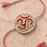 Om Motif Embellished with Red, White, and Golden Beadwork Rakhi - Western Era Rakhi for women