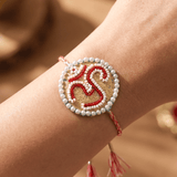 Om Motif Embellished with Red, White, and Golden Beadwork Rakhi - Western Era Rakhi for women