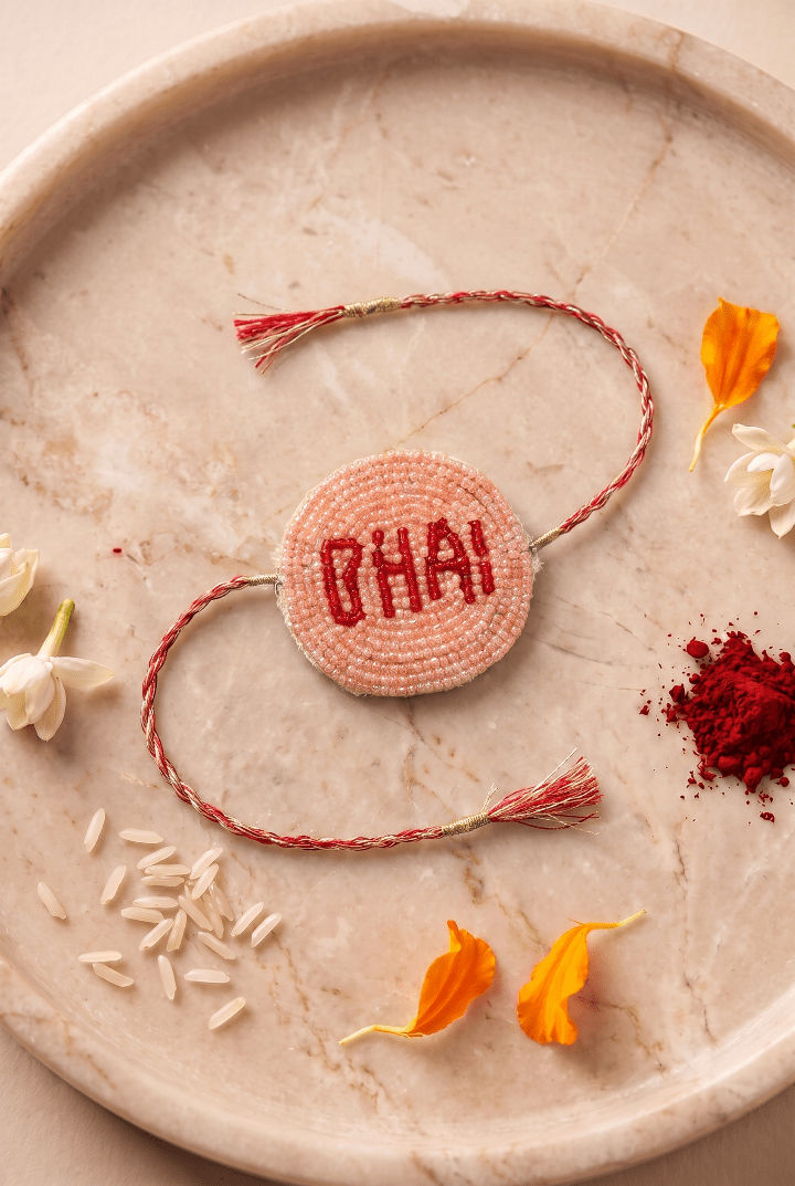Peach / Red Pleated Rakhi with Bhai Motif - Western Era Rakhi for women