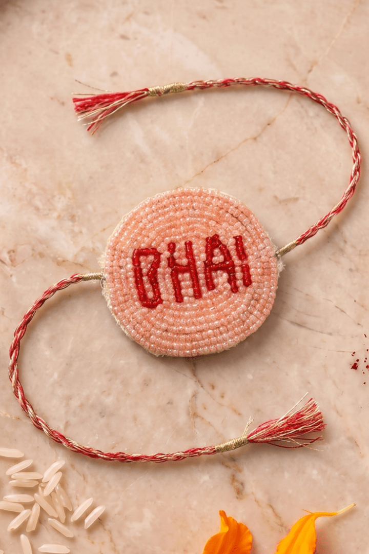 Peach / Red Pleated Rakhi with Bhai Motif - Western Era Rakhi for women
